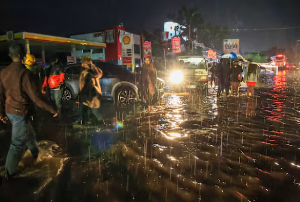 People walk through floodwaters after heavy rains in Nairobi, Kenya, on Saturday, March 7, 2026