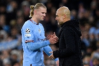 Manchester City head coach Pep Guardiola and Erling Haaland