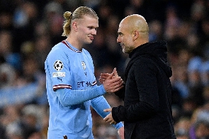 Manchester City head coach Pep Guardiola and Erling Haaland