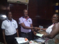 Some officials of Unique Life Assurance presenting cheque to a beneficiary