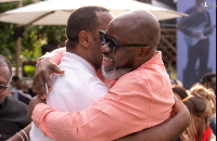 Srem-Sai and Archer in a tight hug at an event