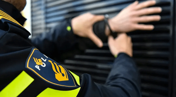 File photo of Dutch police officers arresting a man