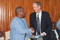 Alex Segbefia, exchanging agreements with Mr Markus Gemuend, Head of Africa, Roche