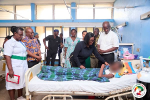 Obuobia Darko-Opoku (wearing black) sharing encouraging messages with a patient