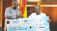 Mr Nortey Omaboe presenting a dummy cheque for GH