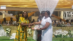 Esther Jones Safo, (left) presents a retiree with a token at the event
