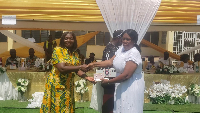 Esther Jones Safo, (left) presents a retiree with a token at the event