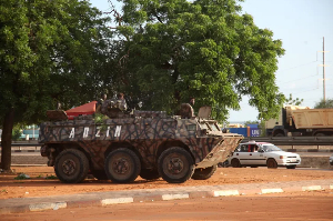 Military armoured vehicle takes position after mutineers attack the airport and presidential palace