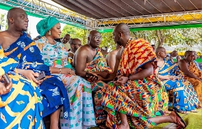 Dr. Mathew Opoku Prempeh kneeling before Mahamudu Bawumia and other dignitaries