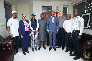 The minister [blue suit] in a photograph with the Professional Golfers’ Association, Ghana
