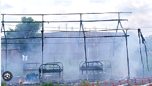 Hospital beds are seen amid the remains of an Ebola treatment center destroyed by a fire Hospital beds are seen amid the remains of an Ebola treatment center destroyed by a fire