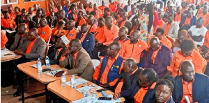 Members of the Uganda National Teachers Union listen to their general secretary during a meeting