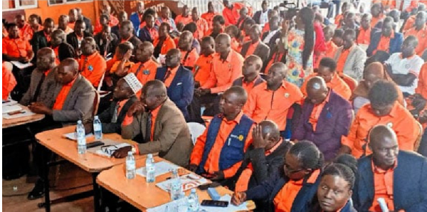 Members of the Uganda National Teachers Union listen to their general secretary during a meeting