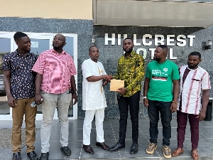 Abdul Hakeem Mahama presenting the cash donation to some members of the youth wing