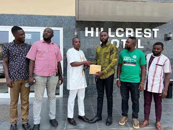 Abdul Hakeem Mahama presenting the cash donation to some members of the youth wing