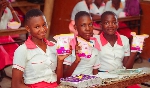 Basic pupils showing the sanitary pads they received from the foundation