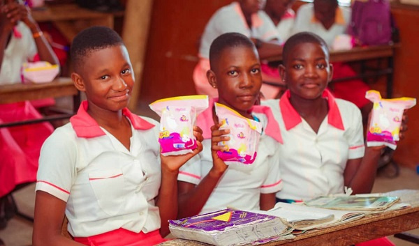 Basic pupils showing the sanitary pads they received from the foundation
