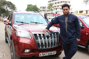 Kwadwo Safo Jr, CEO of Kantanka Automobile standing beside the company