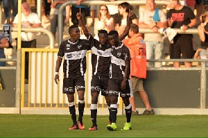 Ocansey is joined by teammates to celebrate his goal
