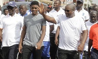 Sharaf (in ash t-shirt with his dad during a fitness exercise by the Ghana leader)