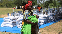 A villager arrives to collect her monthly allocations of food aid provided by the World Food Program