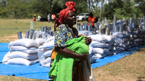 A villager arrives to collect her monthly allocations of food aid provided by the World Food Program