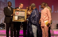 Vodafone Ghana Management Team honouring J.A Kufuor (2nd R) at the 10th anniversary