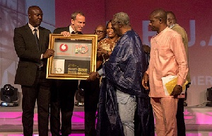 Vodafone Ghana Management Team honouring J.A Kufuor (2nd R) at the 10th anniversary