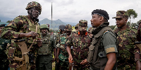 Kenyan army Colonel Denis Obiero (left) talks with M23 spokesman Willy Ngoma (right) in Kibumba