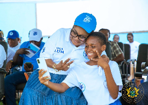 First Lady Lordina Mahama in a pose with a student