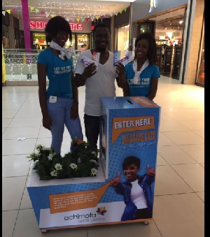 A happy shopper (middle)shows off a bunch of shopping vouchers he won in the Pay Your Bill promo