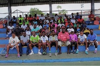 The promising tennis stars in a group picture with coaches and organizers