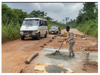 Snipped of the teacher filling potholes