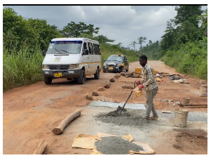 Teacher Repairs Potholes