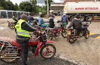 Motorcycle taxi drivers queue to refuel at a petrol station in Karatina, Kenya