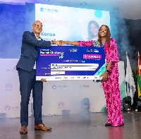Ecobank's Group CEO, Jeremy Awori, hands over the grand prize of US$50,000 to winner Koree