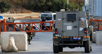 An Israeli army vehicle passes near the closed entrance of Hebron, in the Israeli-occupied West Bank