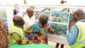 Senior Minister Yaw Osarfo Marfo being shown the artistic impression of the interchange