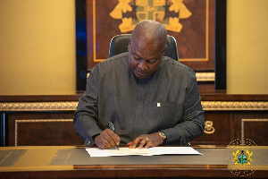 President Mahama signing the Act into law