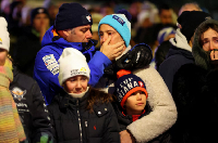 People react outside the Le Constellation bar, after a fire and explosion during a New Year's event