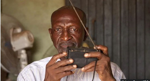 Baba Bala spends most of his time at the shop listening to the news on his radio