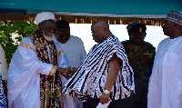 President Akufo-Addo in a handshake with Chief Imam while his Dr. Bawumia looks on.