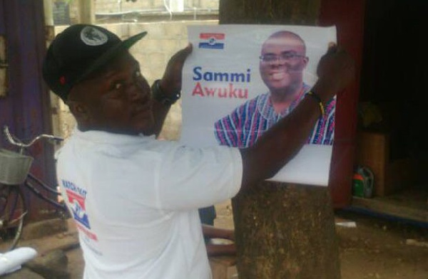 An NPP supporter pasting Sammi Awuku