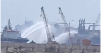 Videos posted on social media showed tugboats hosing down the ships with water