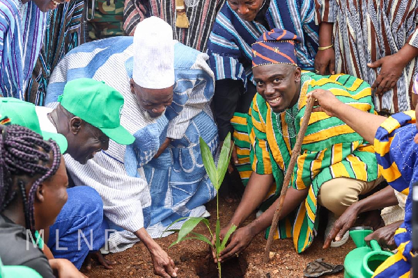 Akwasi Konadu is seen here planting a tree with the Yaa-Naa