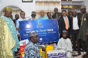 Qnet officials donating food items and cash to Chief Imam