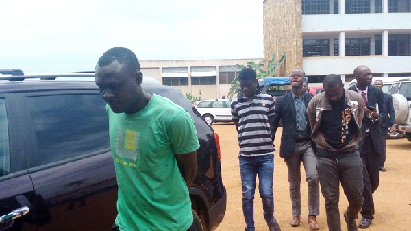 The three accused persons being escorted out of the court premises