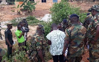 Soldiers at the scene of the murder of Captain Mahama