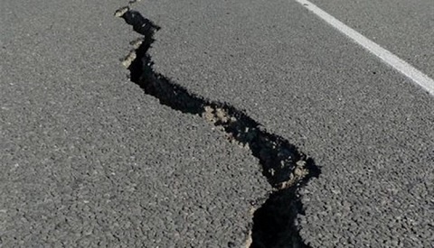 A tarred road split open after earthquake (file photo)