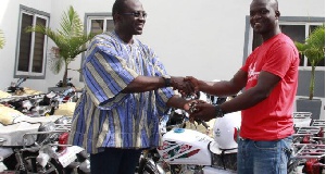 Former BOST C.E.O, Kwame Awuah-Darko handing over the motorbikes to beneficiaries